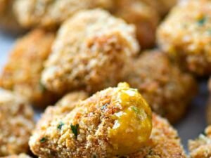 Breaded chicken nuggets with sauce.