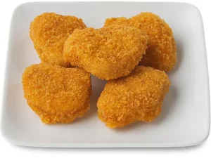 Golden chicken nuggets on plate