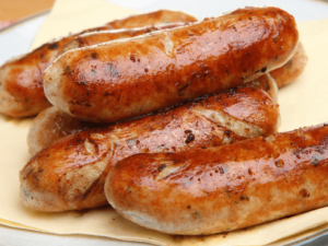 Grilled sausages piled on plate