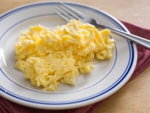 Scrambled eggs on white plate