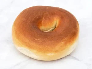 Golden brown bagel on marble.